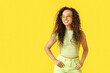 © Pixel-Shot - Happy young African-American woman in sunglasses on yellow background