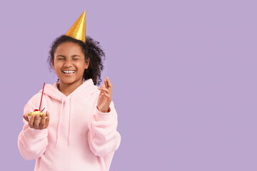 Sticker - Teen African-American girl with birthday cake and crossed fingers making wish on lilac background