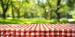 © Nice Seven - Red and White Checkered Tablecloth with Blurred Green Background