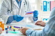 © lenblr - A doctor wearing gloves is engaging with a patient to discuss medical test results, emphasizing the importance of healthcare and diagnostic processes