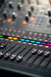 © DedMityay - Professional audio mixing console with colorful illuminated buttons and sliders, used in music production and live performances.