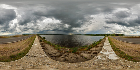 Wall Mural - 360 seamless hdri panorama view near lake before storm with overcast sky and dark clouds in equirect