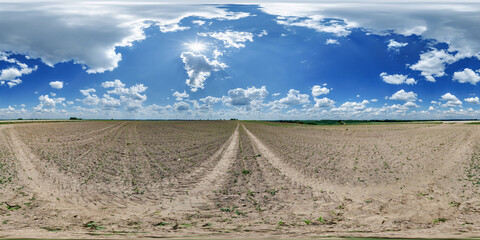 Wall Mural - 360 hdri panorama view on no traffic gravel road among fields in spring day with beautiful clouds in
