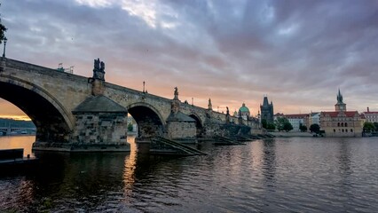 Wall Mural - Motion time lapse view of the Charles Bridge in Prague, Czech Republic, during a colourful summer sunrise