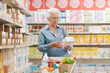 © StockPhotoPro - Senior woman reading information on a product package at the supermarket
