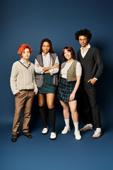 Canvas Print - A diverse group of young friends, stand united in stylish attire against a dark blue background.