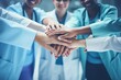 © vladico - A bunch of medical staff put their hands together