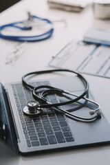 Stethoscope with prescription clipboard and Laptop ,Doctor working an Exam, Healthcare and medical concept,test results in background,vintage color,selective focus