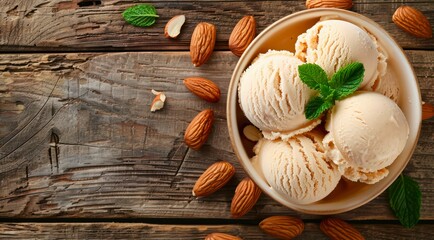 Canvas Print - Bowl with scoops of almond ice cream and nuts on a wooden table, top view.