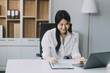 © ARMMY PICCA - Businesswoman working at office with documents on desk, doing planning analyzing the financial report, Asian woman business plan investment, finance analysis concept