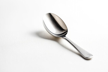 Wall Mural - Silver Teaspoon on White Background