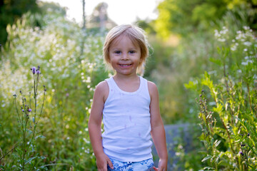 Sticker - Cute portrait of a sweet blond toddler child in garden