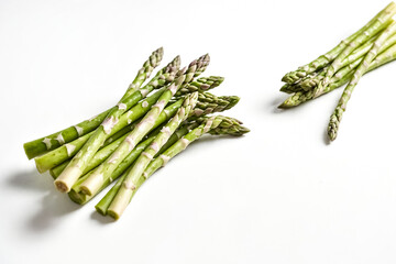 Wall Mural - Green Asparagus Sprigs on White Background
