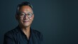 © Pemika - Professional portrait of a confident senior man smiling on dark background with copy space, for business and corporate use