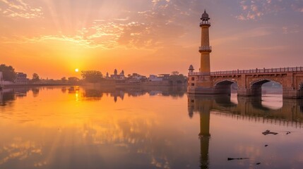 Wall Mural - Majestic Golden Minaret Tower at Dawn with Calm River and Bridge - Peaceful Landscape with Intricate Designs and Patterns