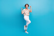 © deagreez - Full body photo of pretty overjoyed lady raise fists triumph attainment isolated on blue color background