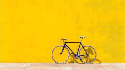 Blue and beige bicycle is parked isolated in front of the yellow wall.