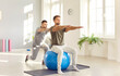 © Studio Romantic - Male caregiver or doctor physiotherapist helping young man doing sport exercises sitting on fit ball in rehabilitation center helping patient in rehab. Physiotherapy and rehabilitation concept.