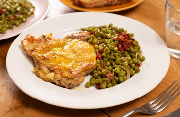 Wall Mural - Delicious crispy chicken with peas as a side dish on a plate