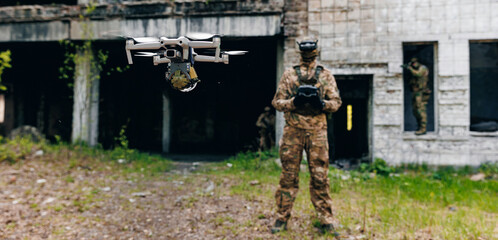 Soldier UAV operator launches army drone with bomb to drop into enemy fortifications and trenches. Concept using military robots in modern warfare