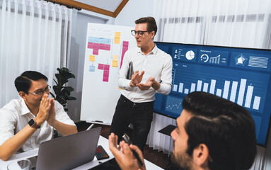 Wall Mural - Presentation in office or meeting room with analyst team utilizing BI Fintech to analyze financial data. Businesspeople analyzing BI dashboard power display on TV screen for strategic planning.Prudent