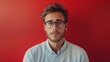 © Saowanee - The young man stood out wearing glasses. red background scene This emphasizes his stylish and smart appearance. Create an attractive and memorable image.