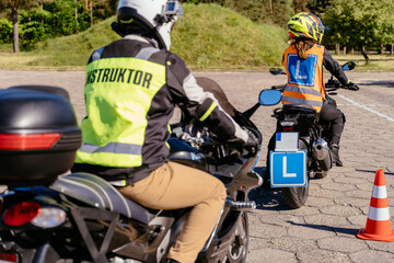 Wall Mural - A man in a yellow jacket is riding a motorcycle with