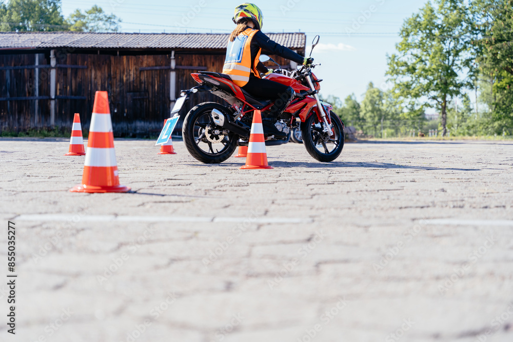 L Driver Cone L-driver person drives slalom through the orange cones on motordrome on ...