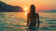 © arhendrix - A serene scene of a woman wading in tranquil ocean waters during a breathtaking sunset, surrounded by mountains and nature.