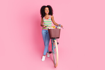 Sticker - Full length photo of charming attractive lady wear striped singlet driving bike looking empty space isolated pink color background