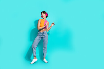 Poster - Full length photo of carefree sweet lady dressed colorful top having fun listening songs earphones empty space isolated turquoise color background