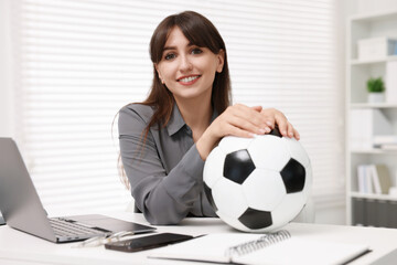 Poster - Smiling employee with soccer ball at table in office