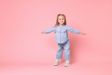 Sticker - Cute little girl dancing on pink background