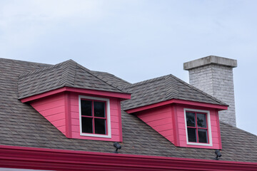 Wall Mural - A red house with a chimney and two windows of garret house.