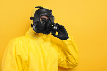 Wall Mural - Worker in gas mask on yellow background. Space for text