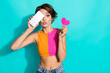 © deagreez - Photo of flirty impressed lady dressed colorful top rising heart modern gadget cover eye empty space isolated turquoise color background