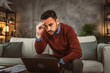 © Miljan Živković - Adult exhausted man man work from home and have dilemma about work