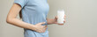 © KMPZZZ - Pain, suffering asian young woman having a stomachache, abdominal pain or digestive, hand in holding belly after drink glass of milk. Lactose intolerance, allergy from dairy food, health care problem.