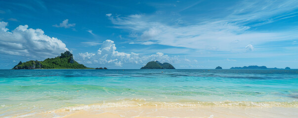 Wall Mural - Beach background with a tropical island in the distance and clear blue water.
