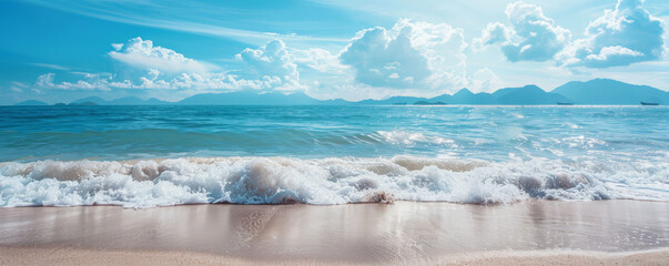 beach background with distant mountains and a clear blue horizon.