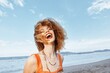 © SHOTPRIME STUDIO - Joyful Wanderlust: Smiling Woman Backpacker Embracing Freedom on Beach