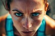© YURY YUTY - Close-up of a person with blue eyes and freckles showing intense focus and determination.