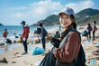 © dreamdes - Young asian woman volunteer collecting garbage on beach. Eco-friendly lifestyle, environmental conservation and protection. Clean nature, ecology and sustainability concept. Eco activism