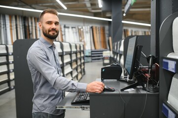 A seller in a wallpaper store