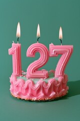 Wall Mural - A pink birthday cake with two lit candles on top