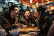© Ilia - Friends Enjoying Street Food at Night Market