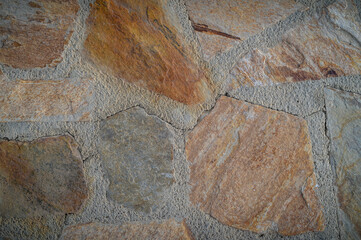 Wall Mural - Stone wall texture background - grey stone siding with different sized stones