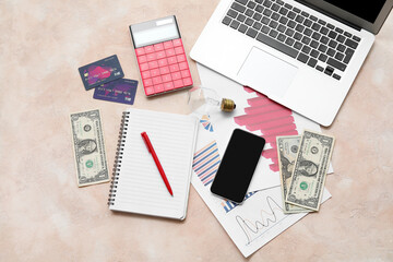 Wall Mural - Laptop, smartphone, calculator, credit cards and money on pink grunge background. House rent concept