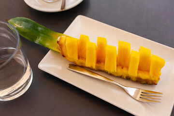 Wall Mural - Beautifully sliced pineapple on white plate, beautiful serving pineapple on festive table