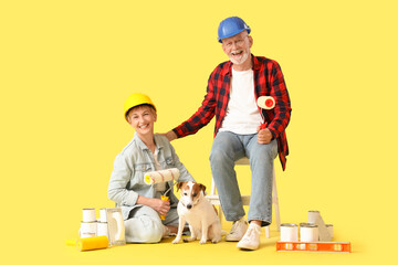 Sticker - Mature couple in hardhats with paint tools and dog on yellow background